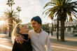 © Xavier Lorenzo/Westend61 - Cheerful young couple at promenade against sky