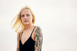 © Uta Konopka/Westend61 - Tattooed young woman against clear sky