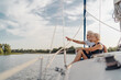 © luengo_ua - Romantic vacation and luxury travel. Senior loving couple sitting on the yacht deck. Sailing the river.