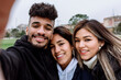 © Xavier Lorenzo/Westend61 - Young man with female friends taking selfie at park