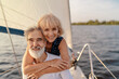Romantic vacation and luxury travel. Senior loving couple sitting on the yacht deck. Sailing the sea.