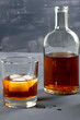 © Michail - Alcohol. Bottle of whisky. A glass of scoth with ice. Copy space. Vertical orientation