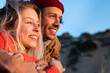© steve brookland/Westend61 - Smiling couple looking at distance with arms around