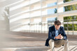 © steve brookland/Westend61 - Businessman smiling while sitting on steps during sunny day