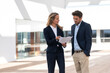 © steve brookland/Westend61 - Businesswoman explaining paper while standing by colleague at office building terrace