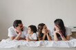 © Olena Bloshchynska - Happy children with their parents on the bed at home.