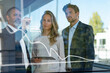 © steve brookland/Westend61 - Male entrepreneur drawing preparing business plan on glass while standing with colleagues at office