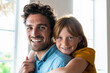 © steve brookland/Westend61 - Smiling daughter embracing cheerful father at home