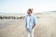 © Uwe Umst√§tter/Westend61 - Handsome man with hands in pockets standing at beach on sunny day