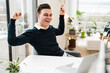 © Uwe Umst√§tter/Westend61 - Cheerful male professional with laptop sitting at table in home office
