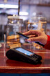 © Veam/Westend61 - Woman using mobile phone for making payment at cafe