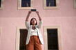 © Veam/Westend61 - Stylish woman taking selfie on smart phone against building