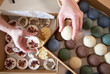 © Veam/Westend61 - Female entrepreneur's hands holding handmade soaps over table