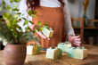 © Veam/Westend61 - Woman showing bar of soap at workshop