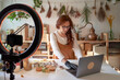 © Veam/Westend61 - Female blogger using laptop while getting ready for video tutorial at workshop