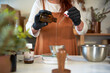 © Veam/Westend61 - Woman measuring essential oil while making soap in workshop