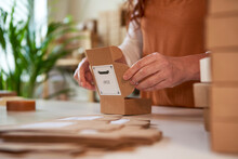 Woman folding boxes for packaging of handmade soaps