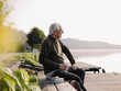 © Gustafsson/Westend61 - Senior man looking at view while sitting on bench