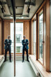 © Gustafsson/Westend61 - Male entrepreneur with arms crossed standing in office corridor