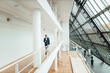 © Gustafsson/Westend61 - Senior male entrepreneur holding digital tablet while walking in corridor at office