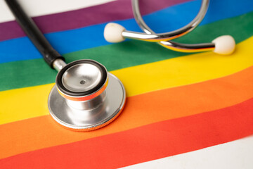 Black stethoscope on rainbow flag background, symbol of LGBT pride month celebrate annual in June social, symbol of gay, lesbian, bisexual, transgender, human rights and peace.