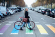 © JOSEP SURIA/Westend61 - Woman with bicycle walking on zebra crossing while looking away
