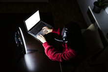 Female Vlogger Using Laptop In Darkroom