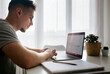 © Marco Govel/Westend61 - Handsome male entrepreneur working on laptop at home office