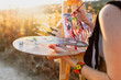 © Manu Reyes/Westend61 - Young woman artist painting on easel