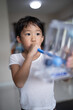 © No-Te - Thin boy uses a Tri-ball Incentive Spirometer for check his lung function.