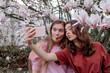 © Oxana Guryanova/Westend61 - Female friends puckering while taking selfie through smart phone
