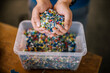 © Daniel Waschnig Photography/Westend61 - Man with container holding recycled plastic in factory
