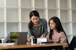 © amnaj - Two Asian businesswoman brainstorm work analyze consult collaborate at the office.