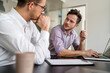 © Daniel Ingold/Westend61 - Male colleagues discussing with each other in office