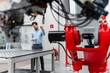 © Daniel Ingold/Westend61 - Young male entrepreneur discussing during video conference through laptop while machinery in foreground at factory