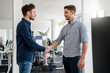 © Daniel Ingold/Westend61 - Handsome business people shaking hands in office