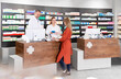 © Florian K√ºttler/Westend61 - Female customer purchasing medicine from pharmacists in store