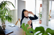 © Jo Kirchherr/Westend61 - Smiling female entrepreneur with hands behind head relaxing on chair at desk in home office