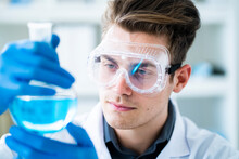 Handsome Male Scientist Examining Chemical In Laboratory