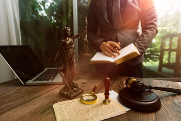 Business and lawyers discussing contract papers with brass scale on desk in office. Law, legal services, advice, justice and law concept