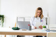 © Giorgio Fochesato/Westend61 - Female healthcare worker using tablet while sitting at desk in medical clinic