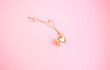 Golden Locket Necklace isolated in pink background