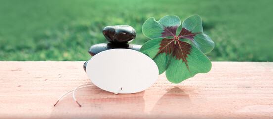 Wall Mural - Black spa stones and four leaf clover . Spa background.