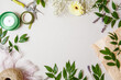 branches with leaves, flowers and florist's work tools on a white background. Flat layout with space for text