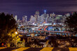 © Tandem Stock - San Francisco, California skyline. Night time image of downtown and the Transamerica building. Crosswalk in the foreground.