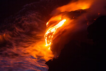 Lava From The Kilauea Volcano On The Big Island Of Hawaii Pours Over Cliffs Into The Pacific Ocean.