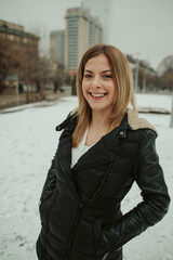 Poster - Happy blonde female in a down jacket outdoor