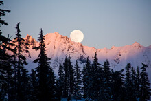 Moonrise Over The North Cascades At Sunset, As Seen From Mount Baker, Washington.