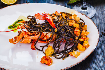 Wall Mural - Squid ink tagliolini with lobster on white plate