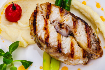 Wall Mural - Grilled fish with mashed potatoes and asparagus on white plate